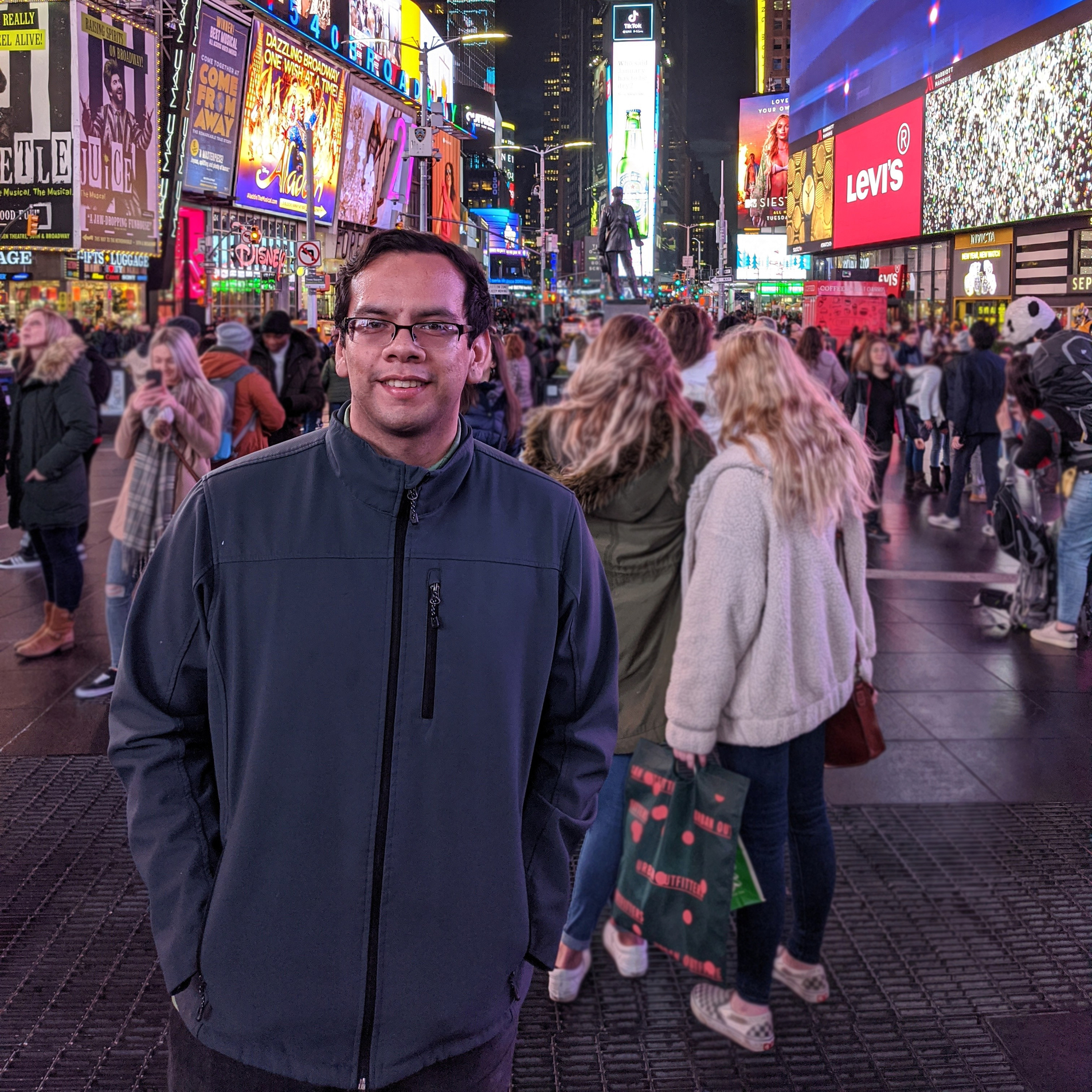 Gabriel Cabrera in front of the iconic screens at Times Square NY.